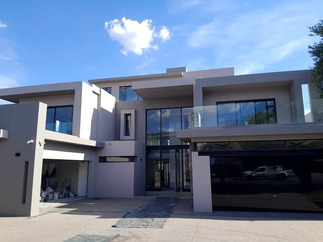 Modern home with glazed entrance and double garage completed by Nelukalo RI Enterprises